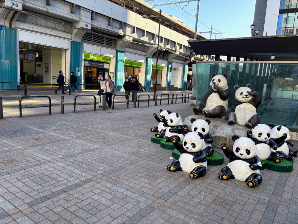Panda sculptures beside a railway exterior near Ueno