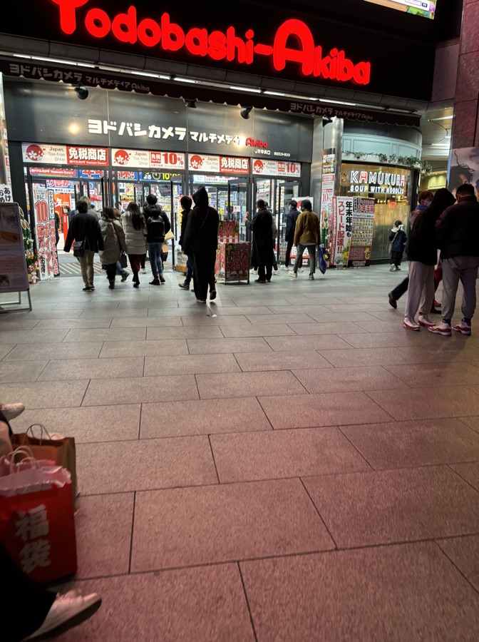 Pedestrians outside Yodobashi-Akiba after dark